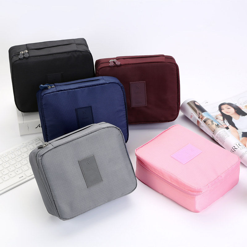 Zenvia Beauty portable cosmetic travel bag with zipper compartments and clear sections for organizing makeup and skincare products.
