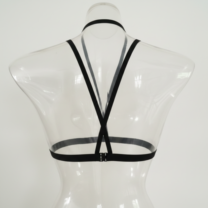 Clear plastic mannequin with black straps on a white background
