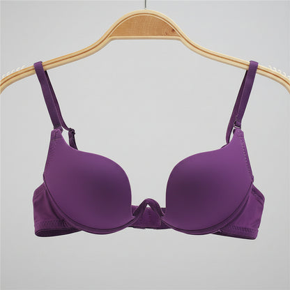 Purple bra on a wooden hanger with a white background