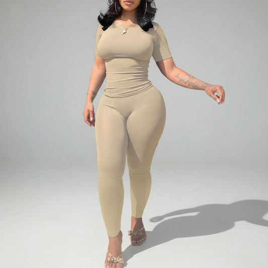 Woman wearing a beige jumpsuit on a white background