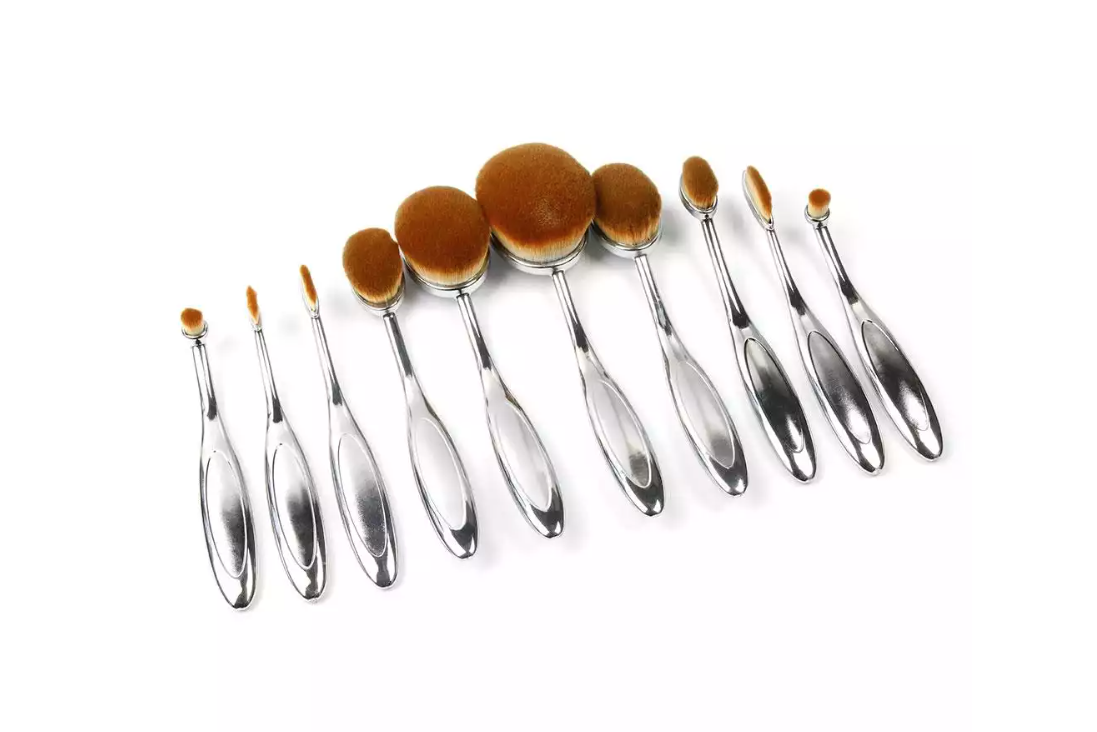 Set of eight oval makeup brushes in various sizes from Zenvia Beauty 10-Piece Oval Brush Set, with soft bristles and sleek handles.