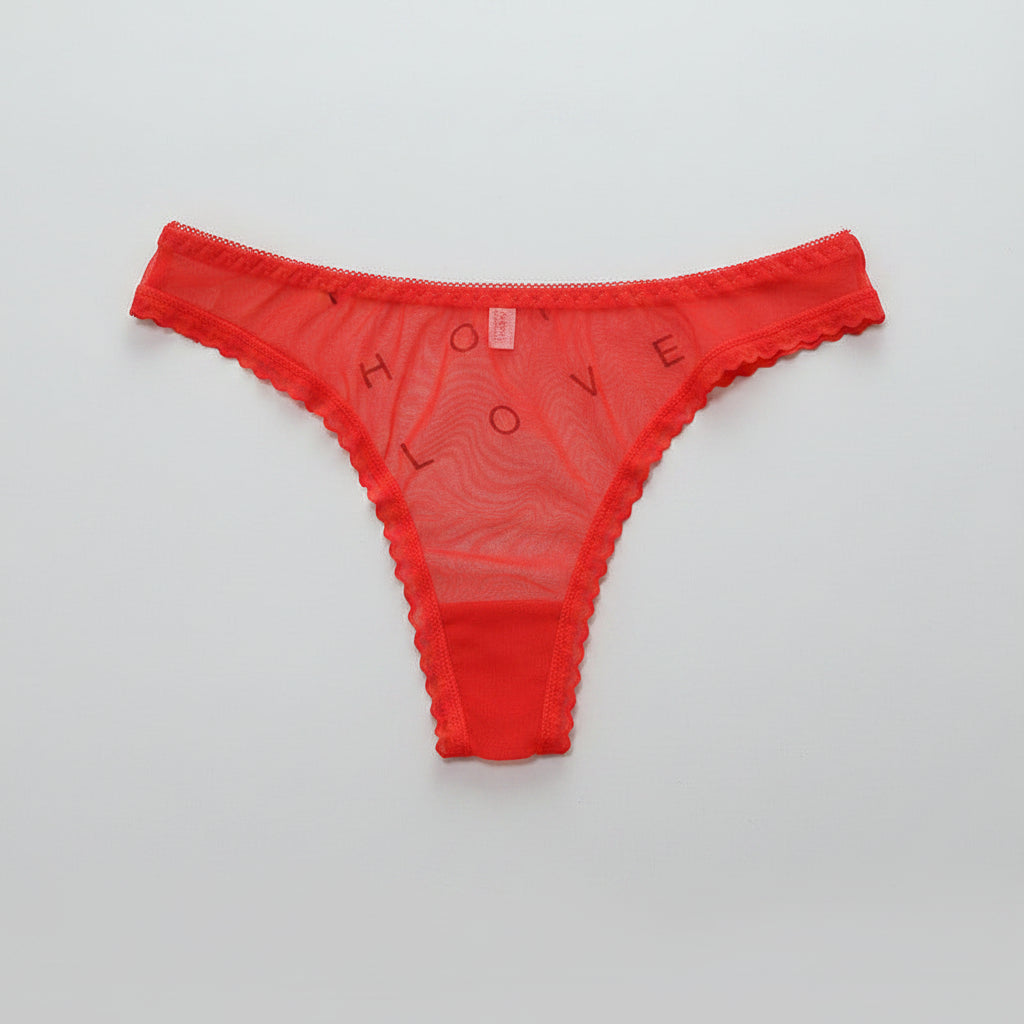 Transparent T-line panties by Zenvia Beauty, featuring sheer fabric and sleek T-back design, shown on a model.
