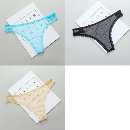 Four pairs of women's underwear in blue, black, beige, and multicolor on a gray surface with a white paper background.