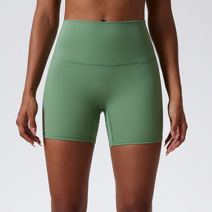 Green athletic shorts worn by a person on a plain background