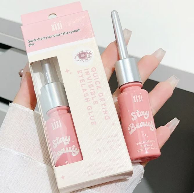 Zenvia Beauty long-lasting eyelash glue in a clear tube, designed for secure and durable eyelash extensions application.