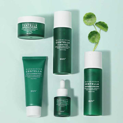 Set of skincare products with green and white packaging on a light blue background