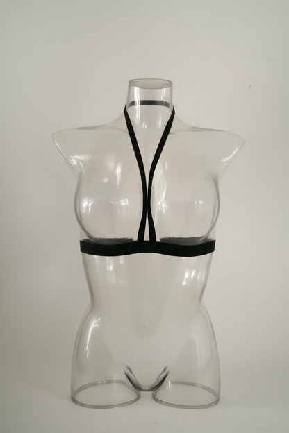 Black strappy top on a transparent mannequin against a white background