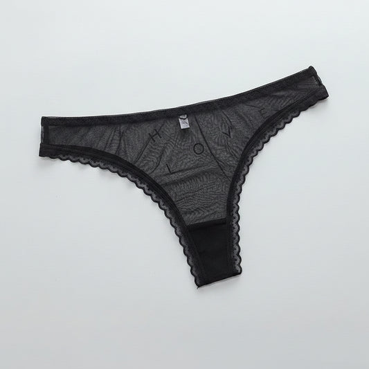 Black lace lingerie on a white surface with 'FAITH HOPE LOVE' text in the background.