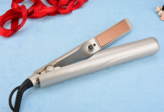 Hair straightener on a light blue background with red ribbon and decorative items.