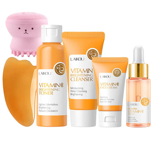Set of skincare products including a brush, toner, cleanser, cream, and serum with visible branding on a white background.