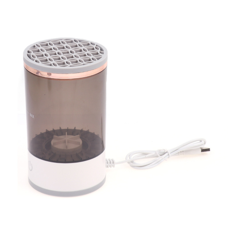 Electric makeup brush cleaner by Zenvia Beauty with a sleek design and cleaning brushes submerged in a clear container.
